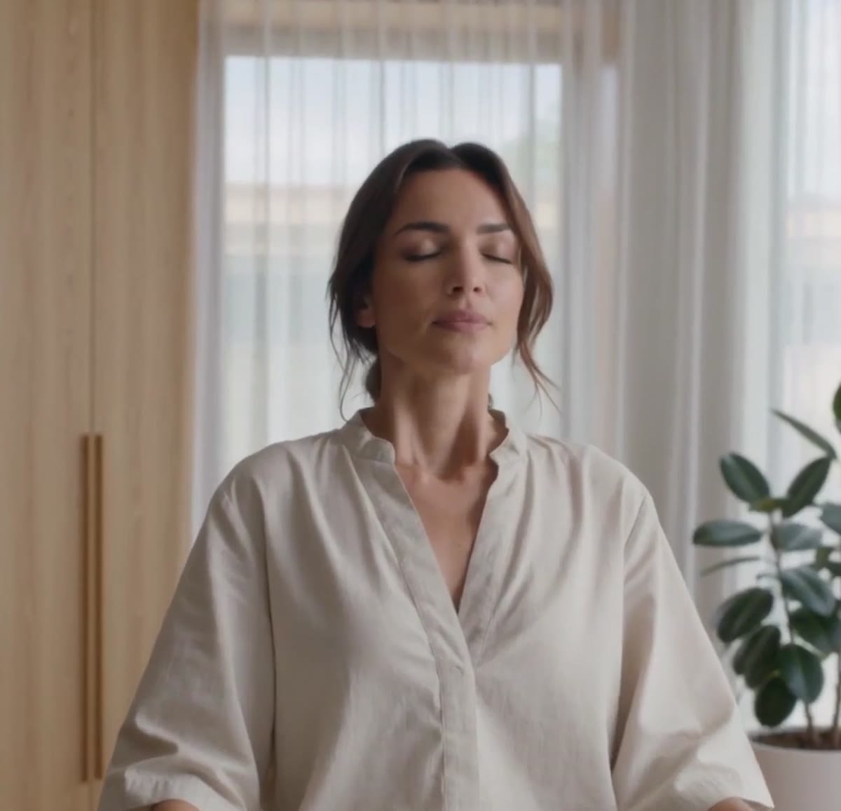 Woman practicing a calm breathing routine in the morning