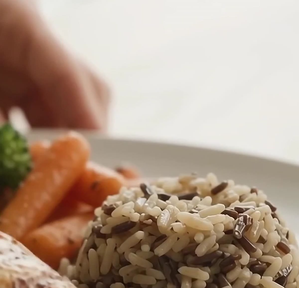 Plate of rice, vegetables and chicken prepared with olive oil