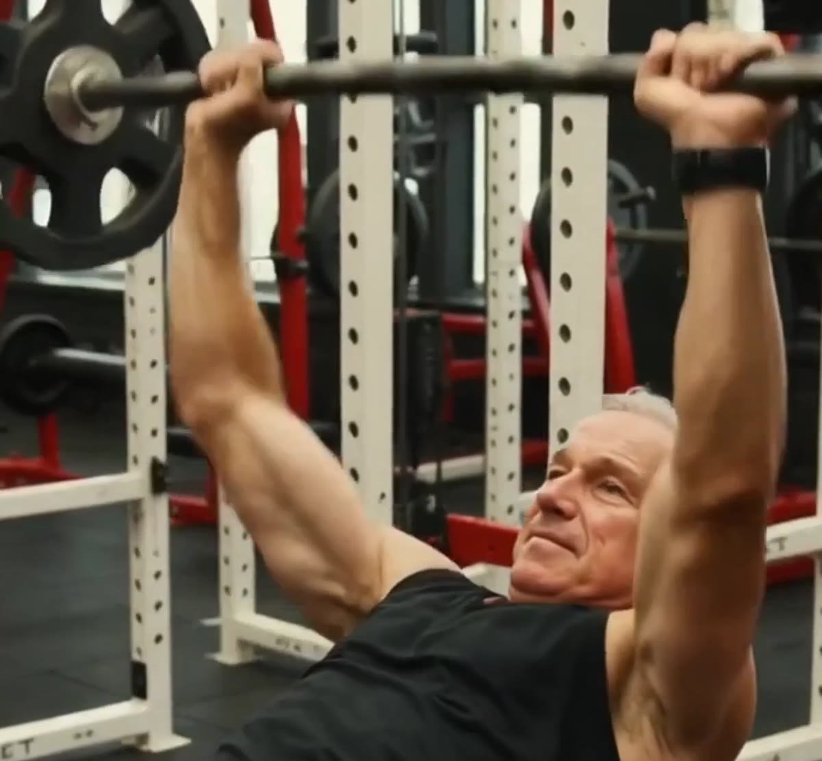 Older man doing a bench press as part of regular strength training
